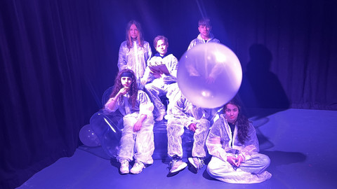 six young people on an inflatable sofa