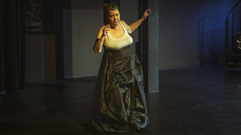 Person dances in the middle of a dark room