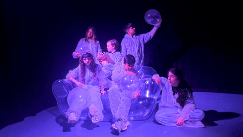 six young people on an inflatable sofa